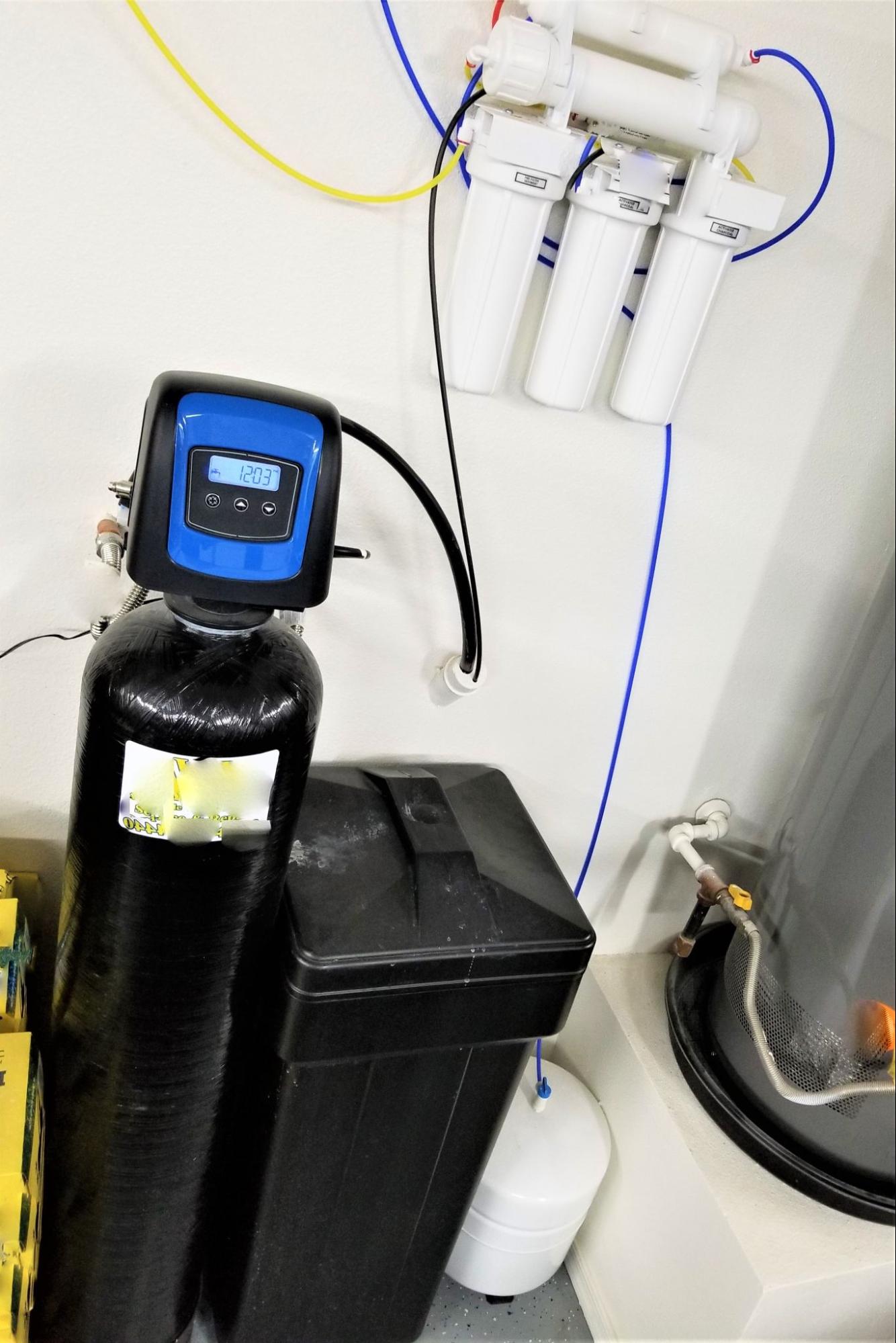 Integrated home water treatment system featuring a water softener for hardness removal and a reverse osmosis unit for drinking water purification.