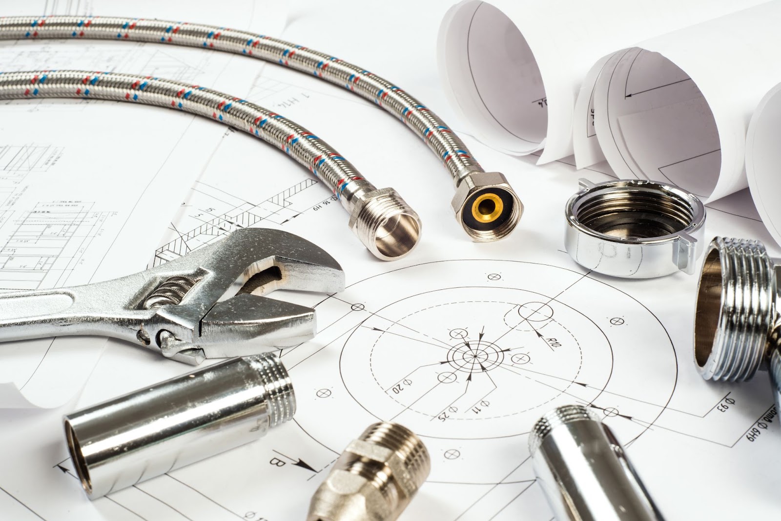 Plumbing materials arranged alongside construction blueprints