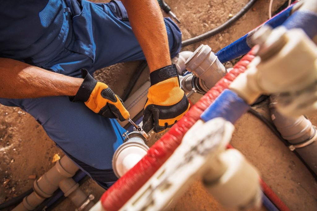 A professional plumber repairing sweater pipes.